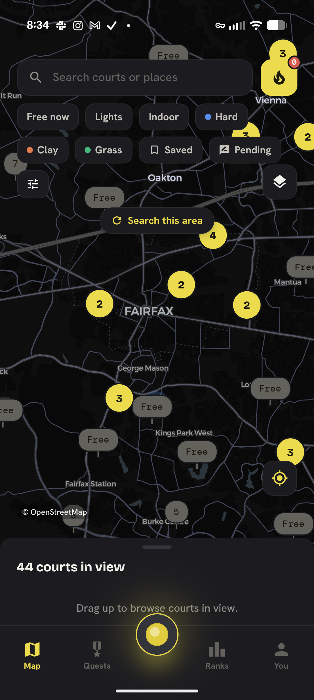 Rally's court map showing clustered court pins with free and busy status over the Fairfax area, with filter chips for surface, lights, and indoor